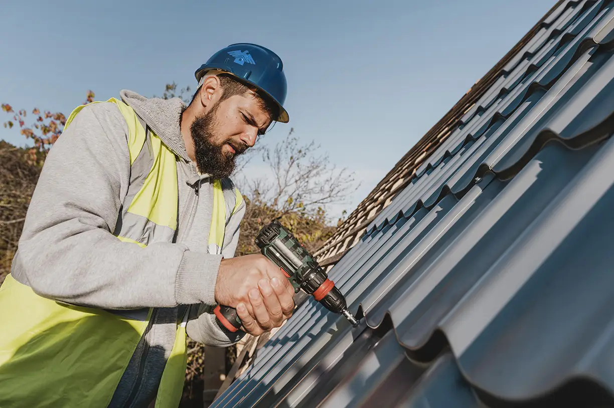 Roofer fastening metal shingle