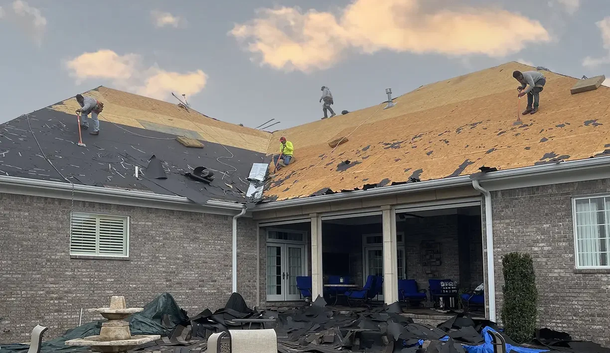 Workers replacing roof on home