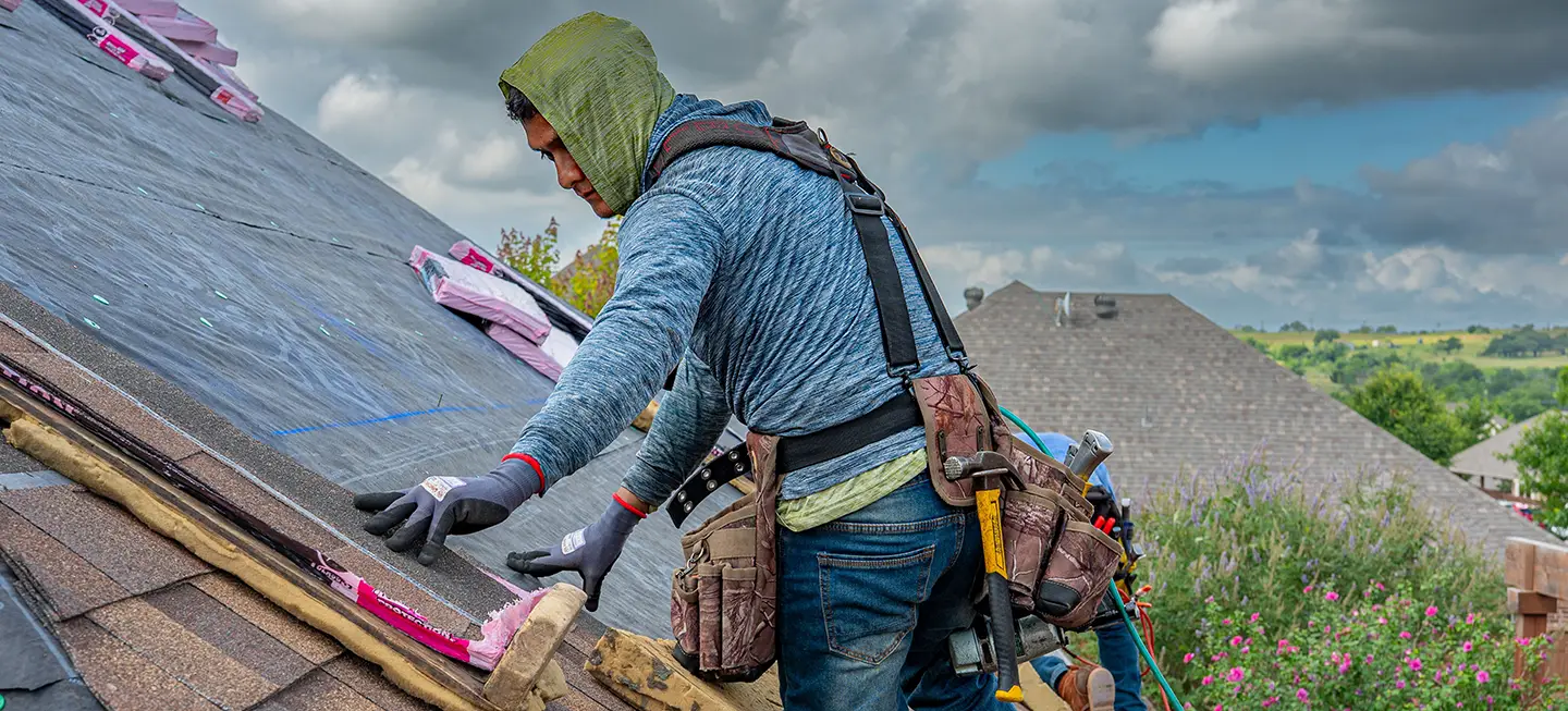 roofer installing asphalt shingles